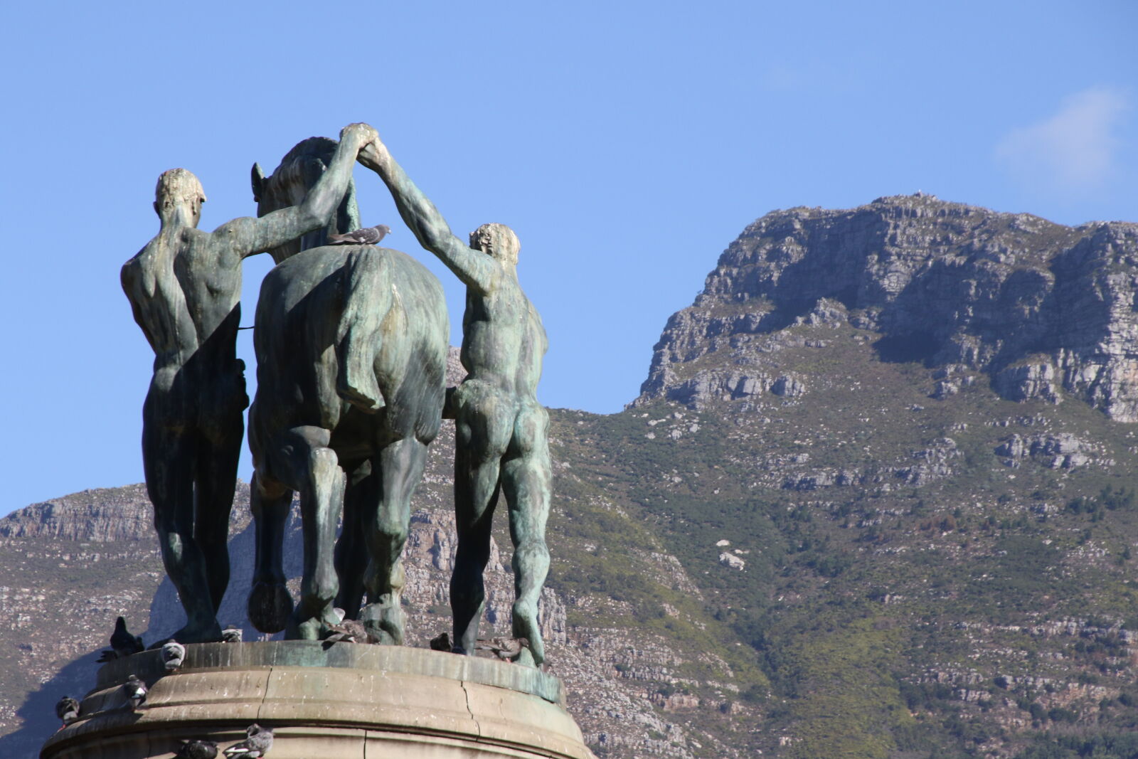 Canon EOS 7D Mark II sample photo. Blue, sky, mountain, statue photography