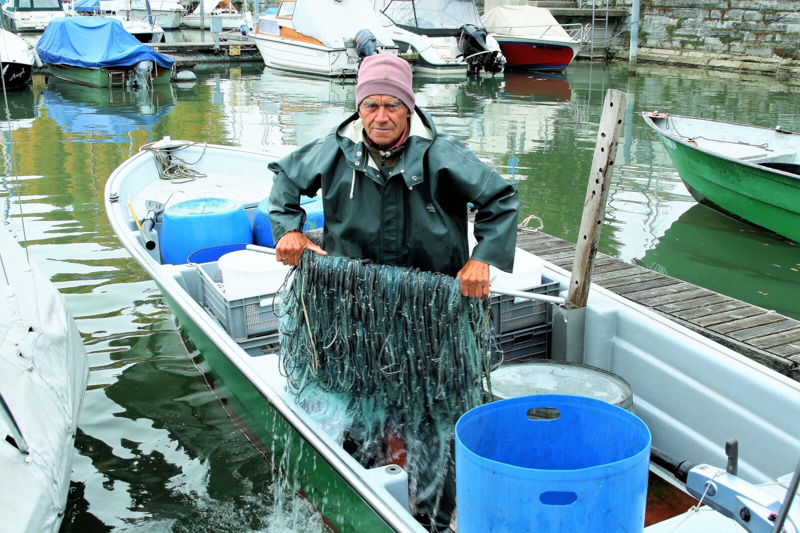 Canon EOS 400D (EOS Digital Rebel XTi / EOS Kiss Digital X) sample photo. The fisherman, older, fish photography