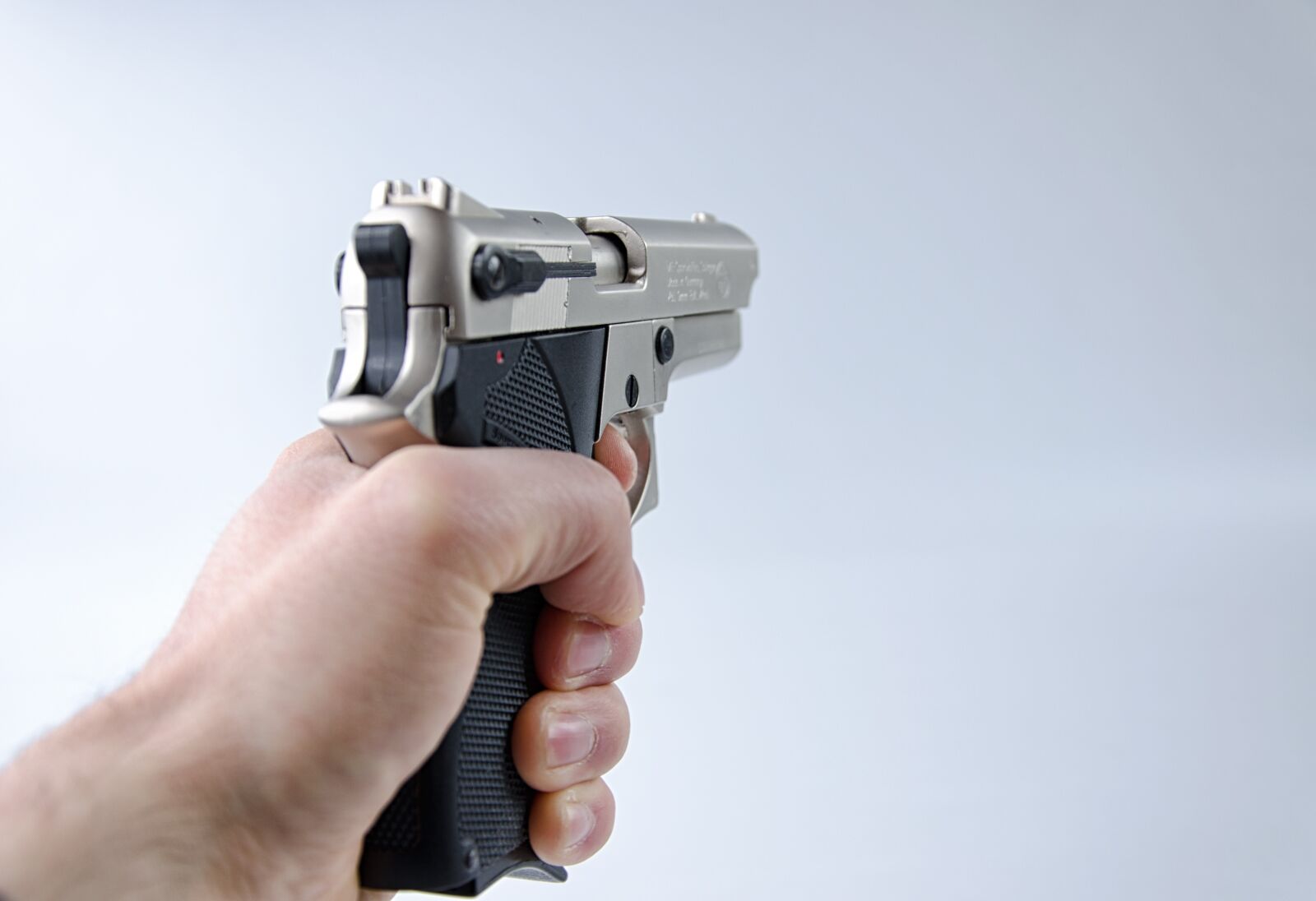 Nikon D5100 sample photo. Hand, pistol, weapon photography