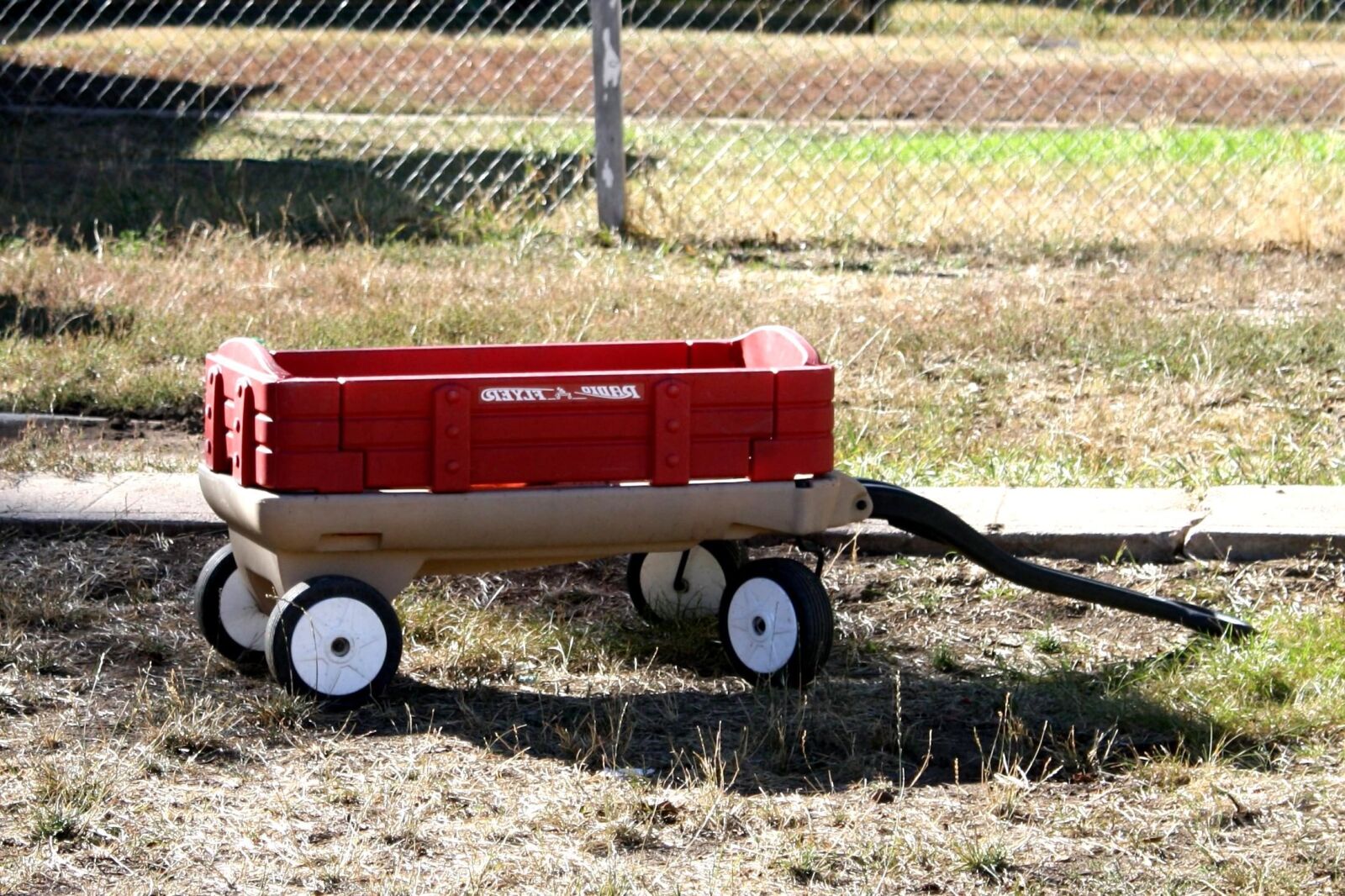 f/3.5-5.6 IS sample photo. Red, wagon, plastic toy photography