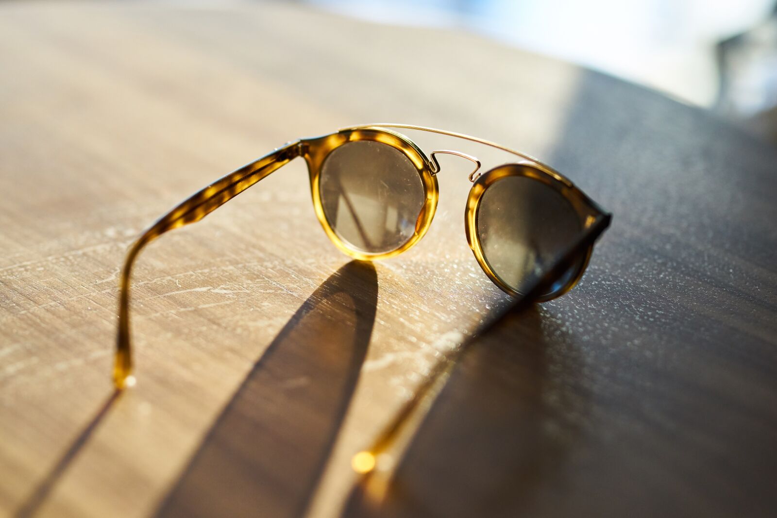Sigma 85mm F1.4 DG HSM Art sample photo. Eyewear, solar, table photography