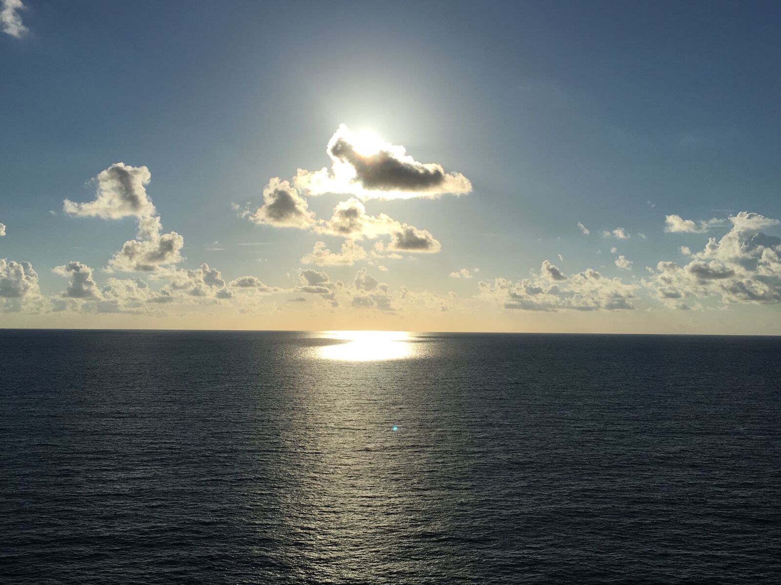 iPhone SE back camera 4.15mm f/2.2 sample photo. Clouds, ocean, reflection, sun photography