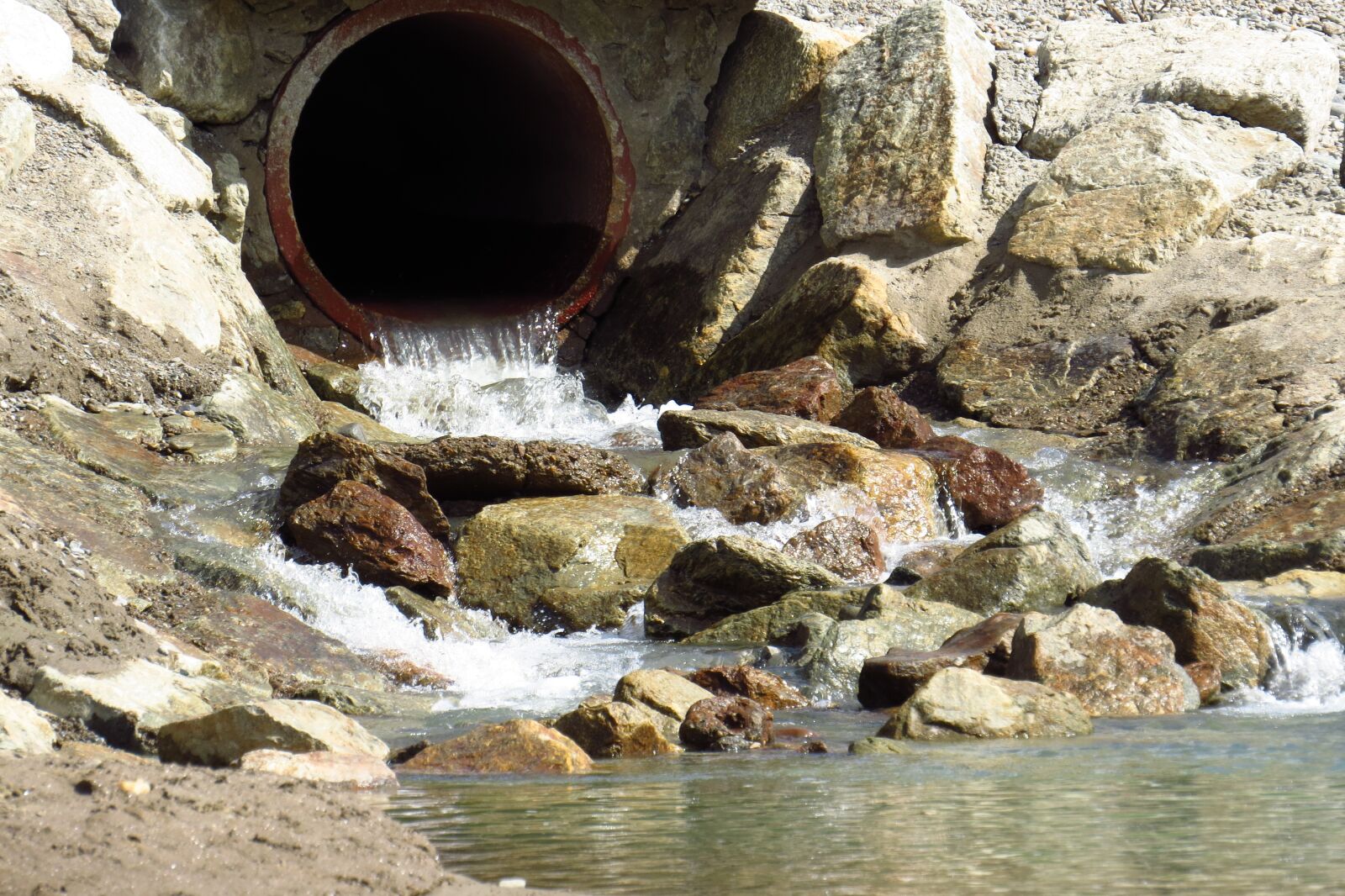 Canon PowerShot SX50 HS sample photo. Water, tube, stones photography
