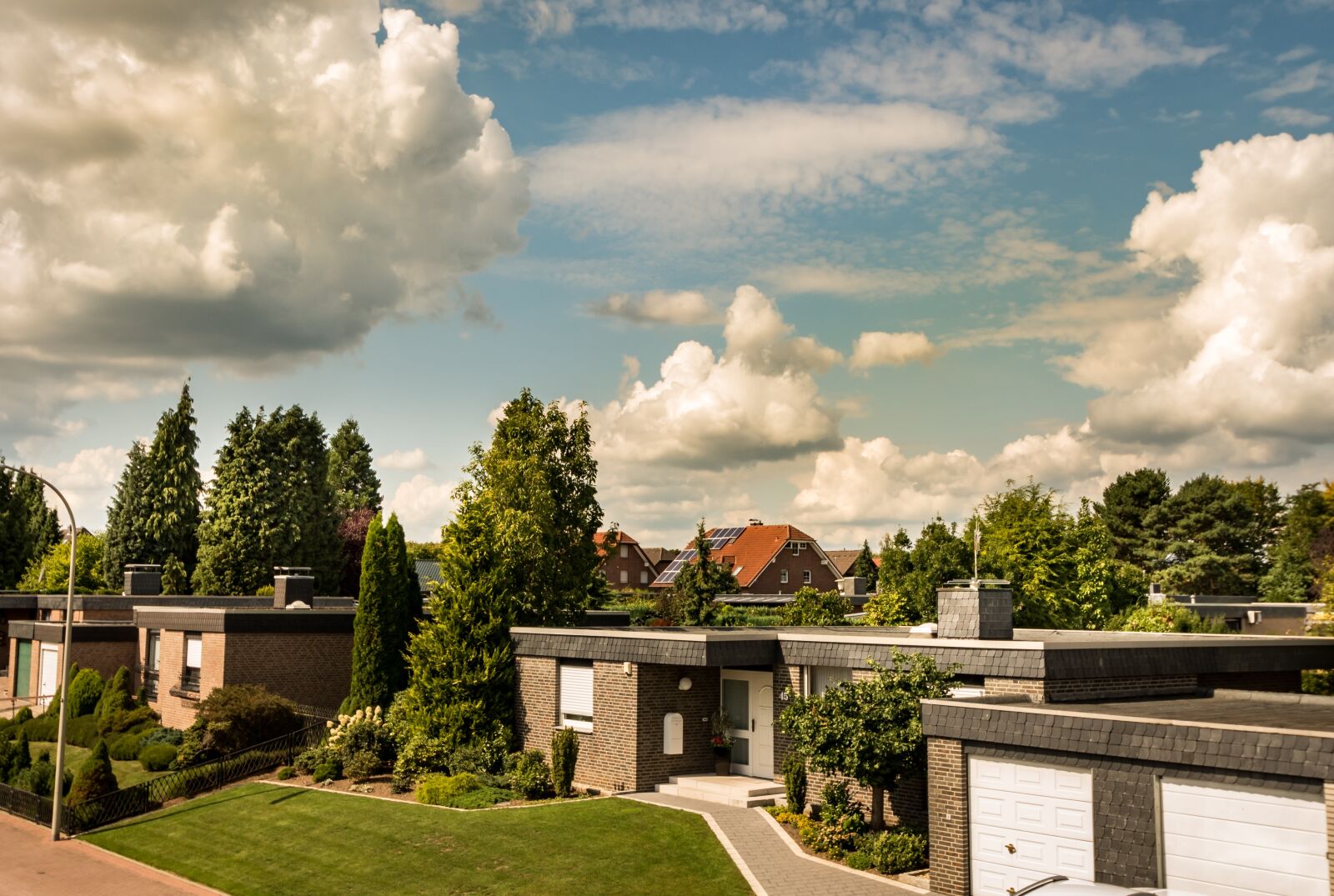 Nikon D750 sample photo. Clouds, residential development, road photography