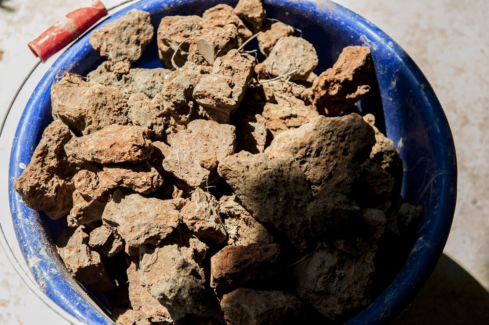 Nikon D700 sample photo. Red earth, bucket, rock photography