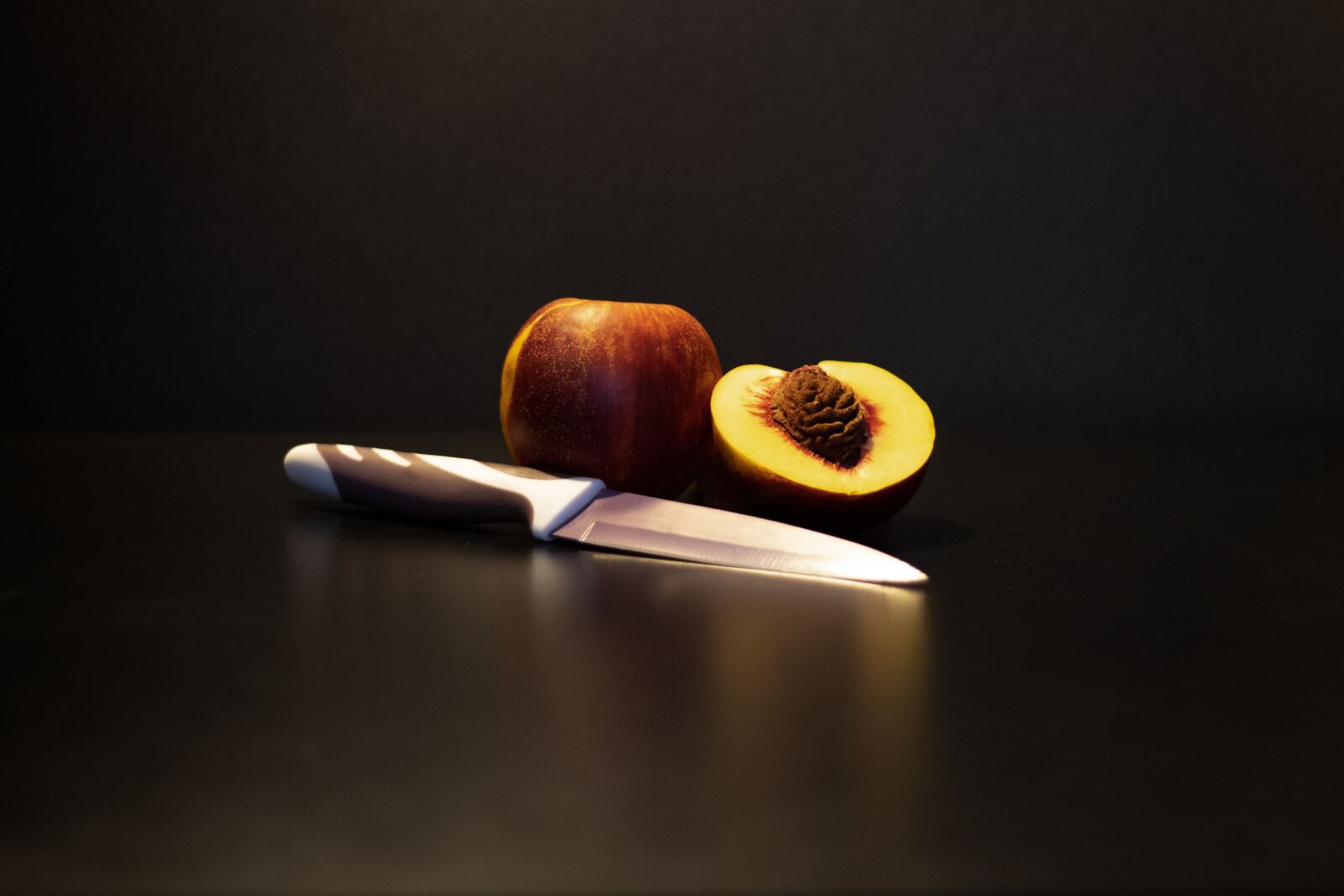 Canon EOS 2000D (EOS Rebel T7 / EOS Kiss X90 / EOS 1500D) + Canon EF 50mm F1.8 STM sample photo. Peach, black background, fruit photography