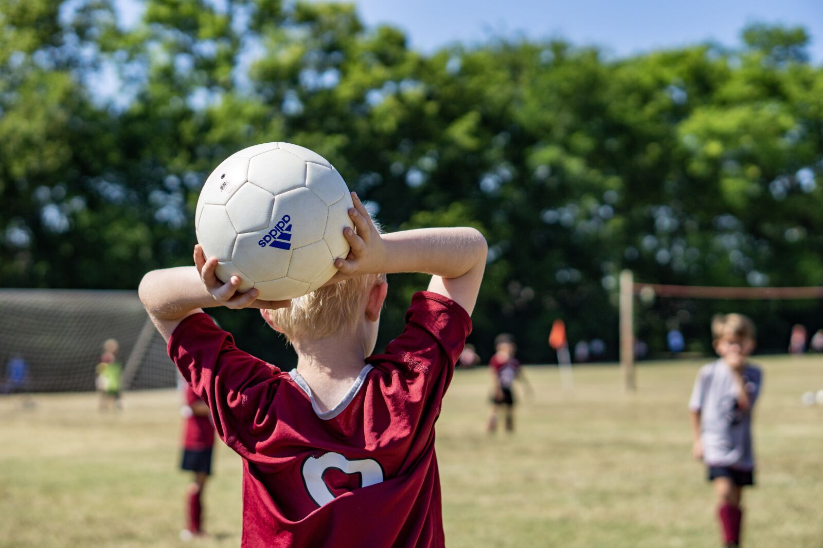 E 50mm F1.8 OSS sample photo. Soccer, throw-in, kids photography