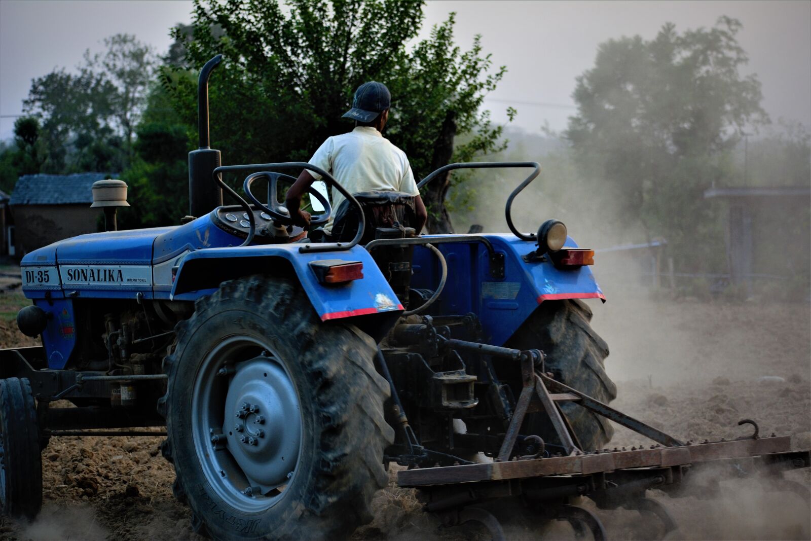 Nikon D5200 sample photo. Farmer, tractor, ploughing photography