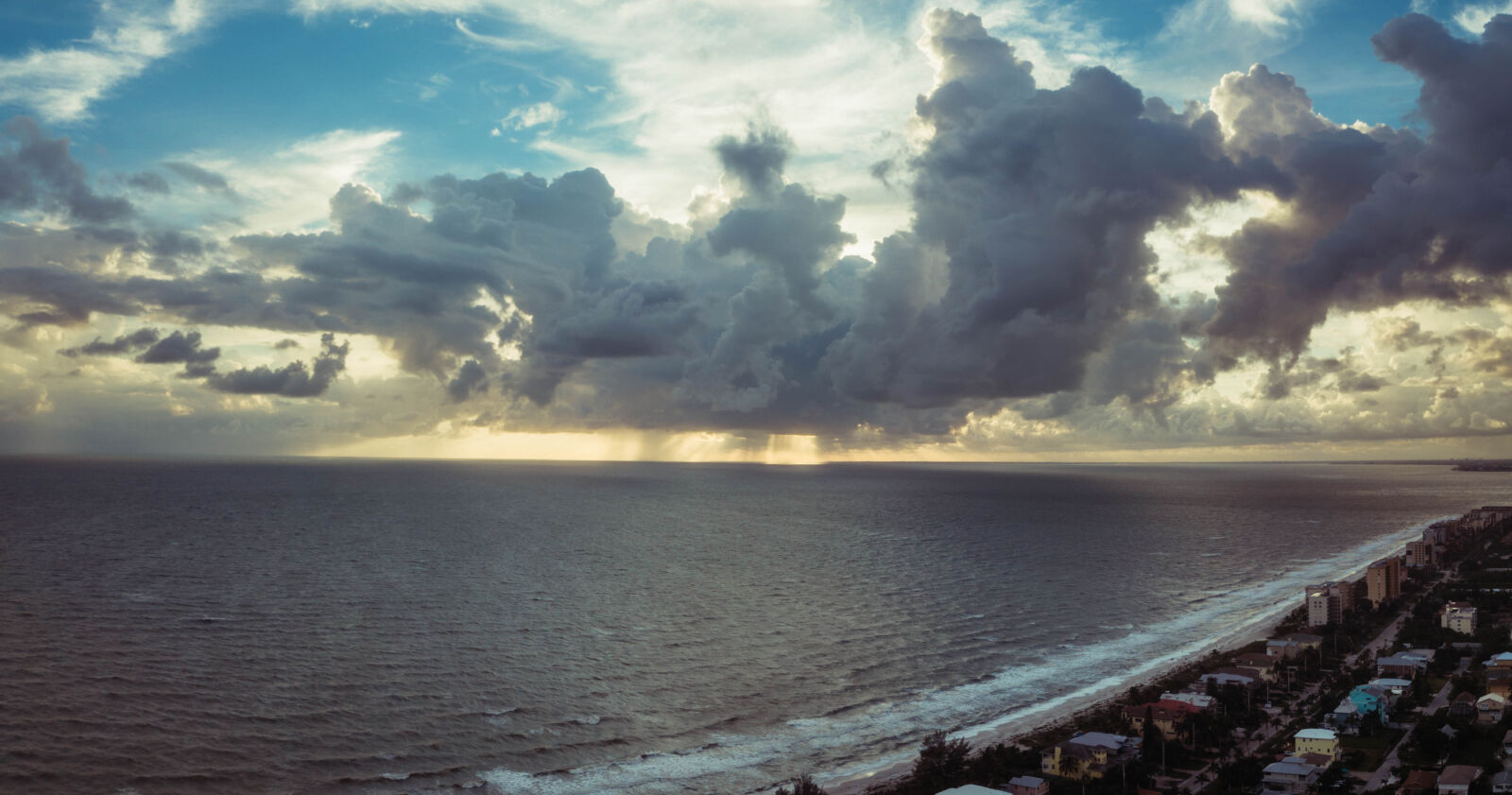DJI FC220 sample photo. Beach, bright, buildings, clouds photography
