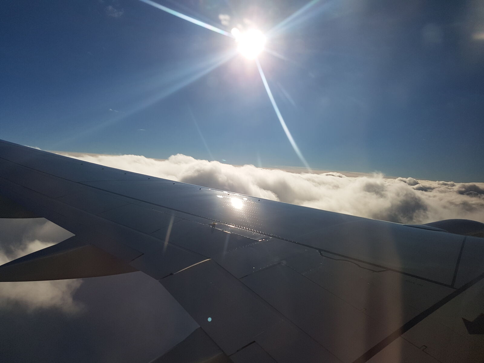 Samsung Galaxy S7 sample photo. Airplane, wing, above, clouds photography