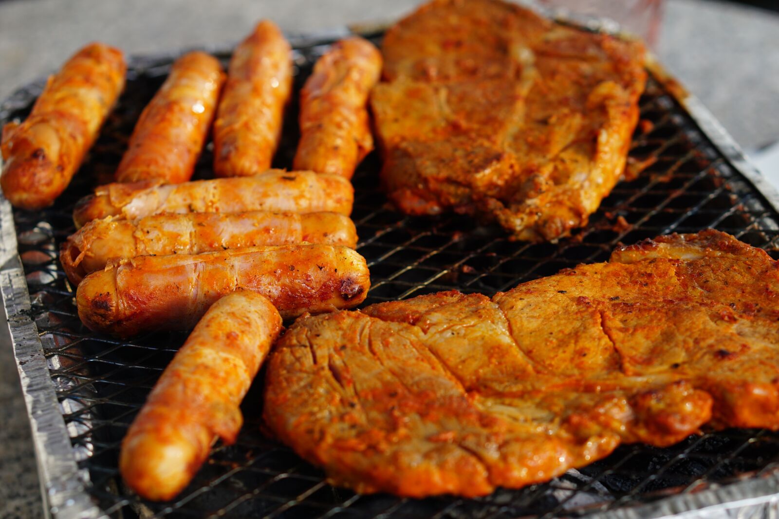 E 50mm F1.8 OSS sample photo. Meat, barbecue, eat photography