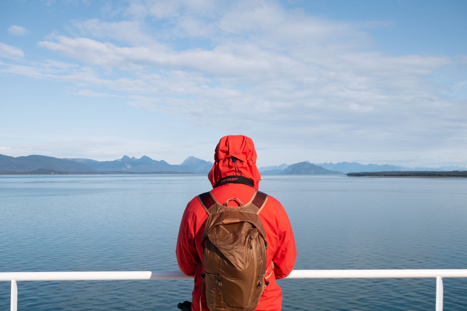 LUMIX G VARIO 12-60/F3.5-5.6 sample photo. Orange jacket, man, mountains photography