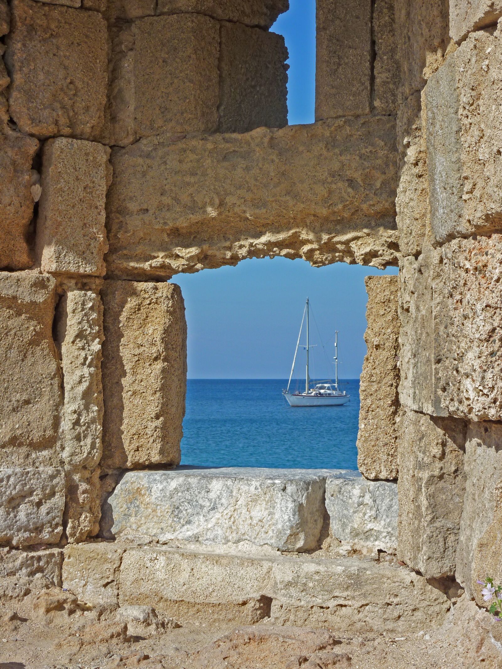 Panasonic DMC-TZ7 sample photo. Stone wall, sea, boat photography