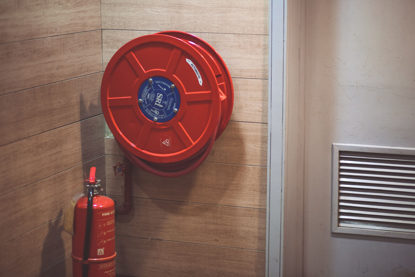 Canon EF 85mm F1.8 USM sample photo. Red, fire, extinguisher, beside photography