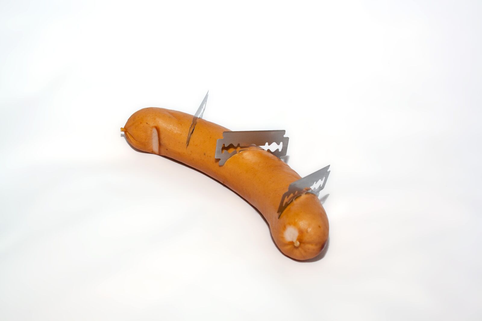 Canon EF-S 18-55mm F3.5-5.6 II sample photo. Sausage, razor blades, poison photography
