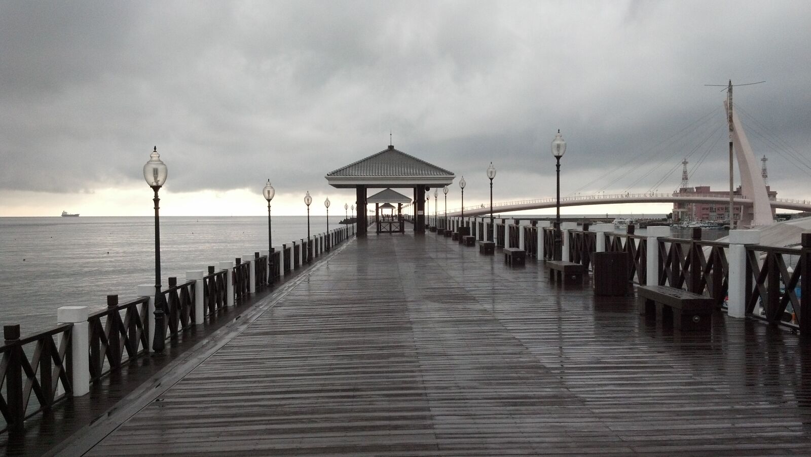 Motorola DROID RAZR sample photo. Rainy day, pier, ocean photography