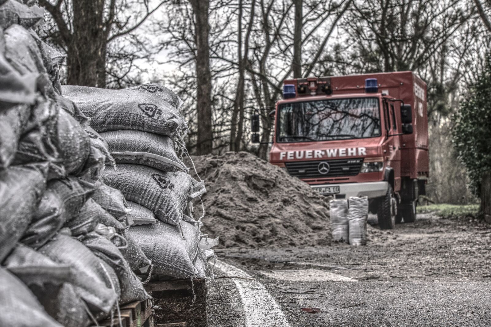 Sony E 55-210mm F4.5-6.3 OSS sample photo. Sand bags, sand, fire photography