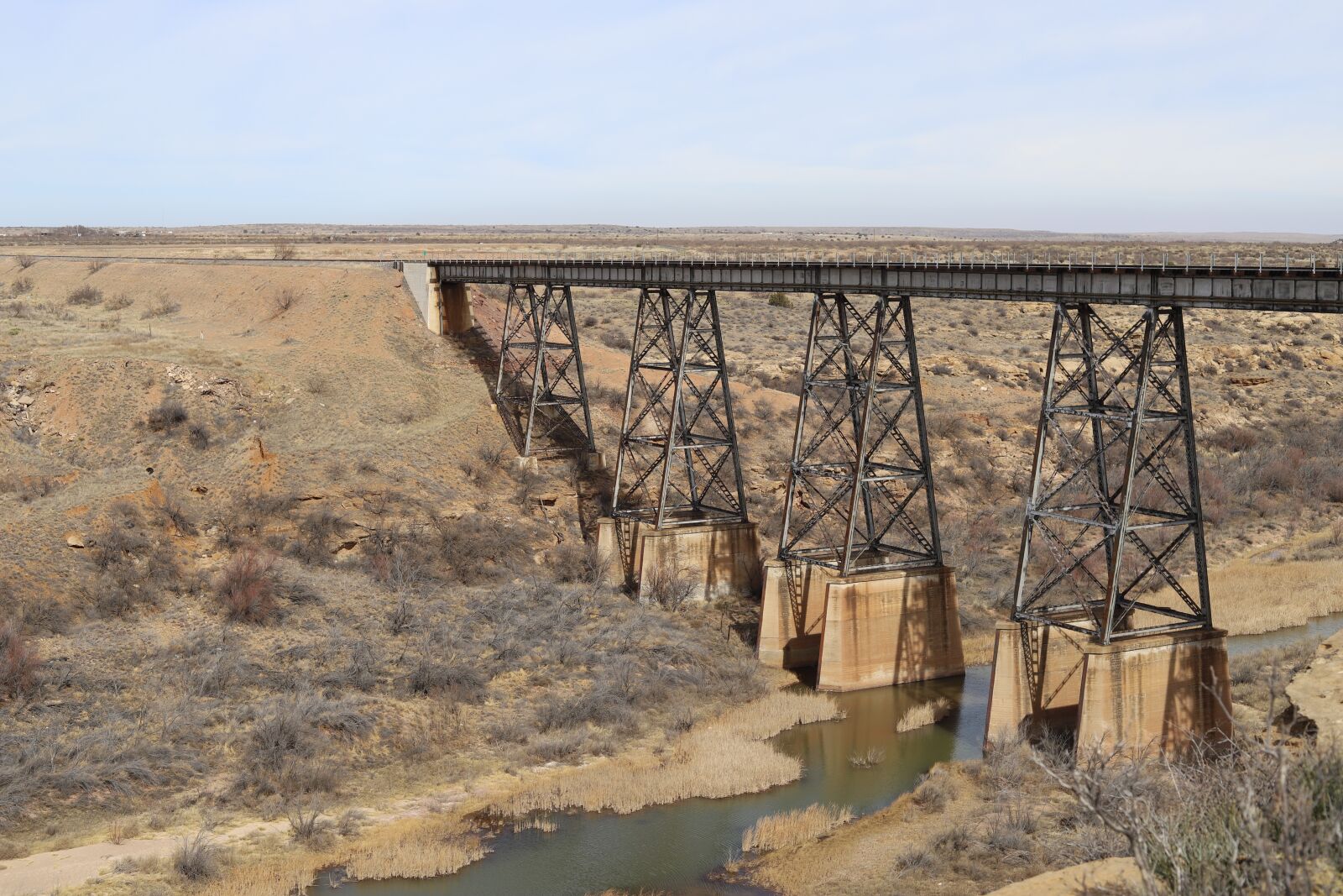 Canon EF 50mm F1.8 STM sample photo. Train trellis, river, dry photography