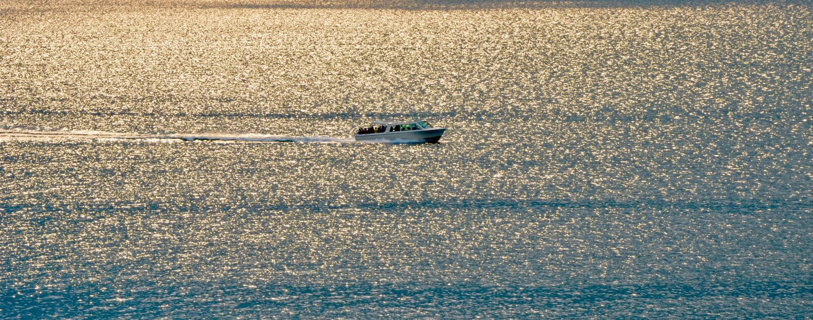 Nikon D5100 sample photo. Powerboat, wave, evening sun photography