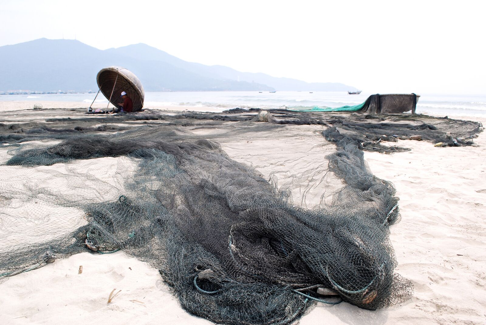 Nikon D60 sample photo. Mending their nets, the photography