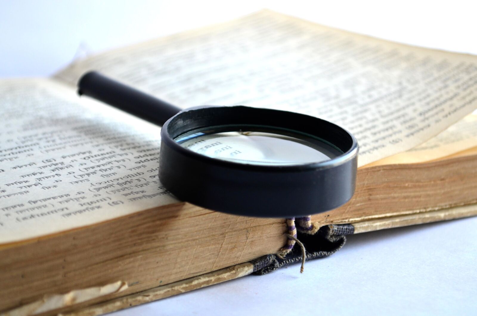 Nikon D5100 sample photo. Book, magnifying glass, dictionary photography