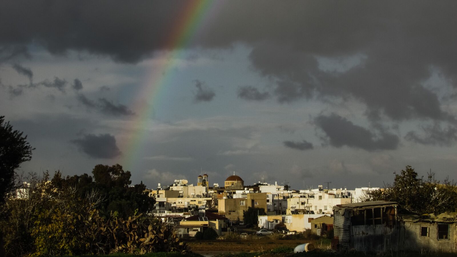 Canon PowerShot SX400 IS sample photo. Rainbow, storm, town photography