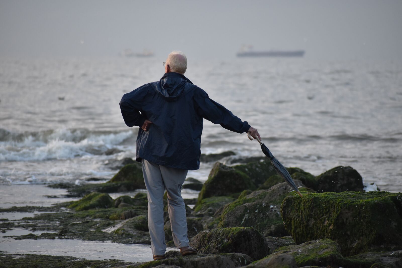 Nikon D3500 sample photo. Man, rocks, ocean photography