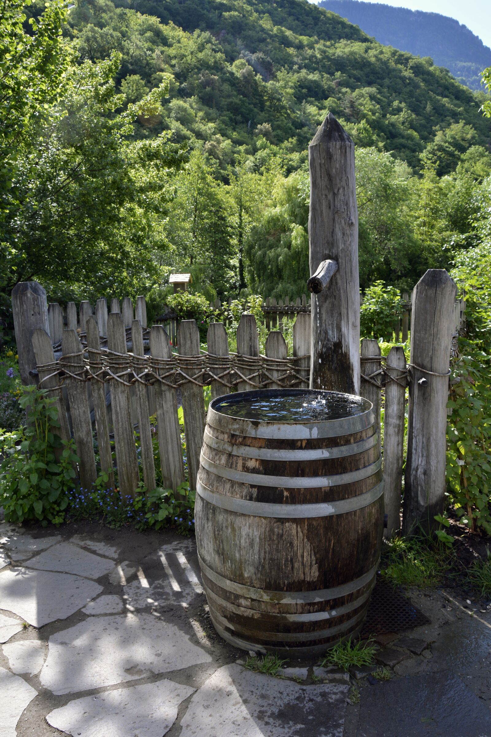 Nikon D7100 sample photo. Fountain, wooden barrels, garden photography