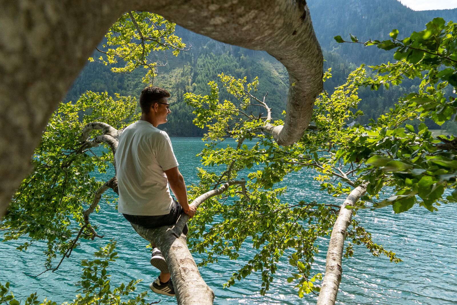 Sony E 18-135mm F3.5-5.6 OSS sample photo. Man, lake, branch photography