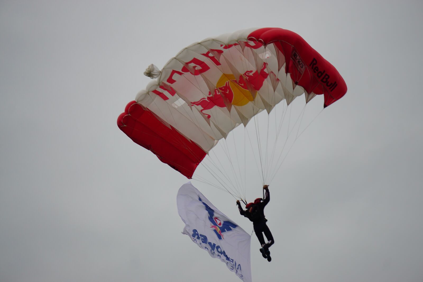 Sony a6000 + Sony E 55-210mm F4.5-6.3 OSS sample photo. Parachute, red bull, airshow photography