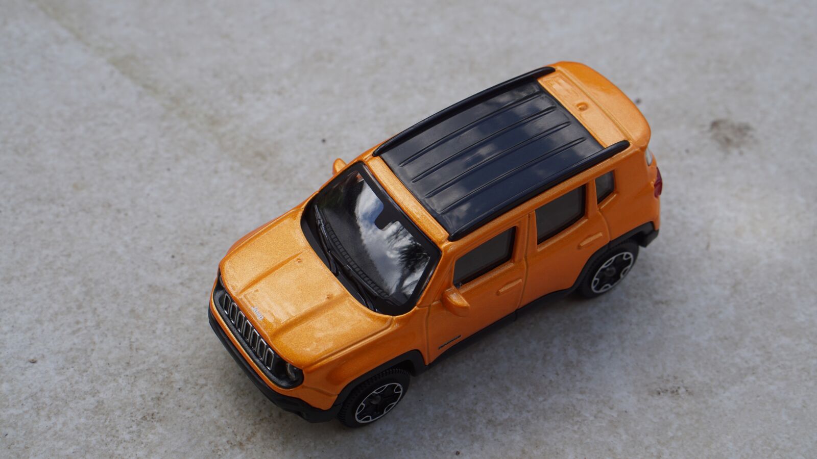 E 50mm F1.8 OSS sample photo. Toy, jeep, yellow photography