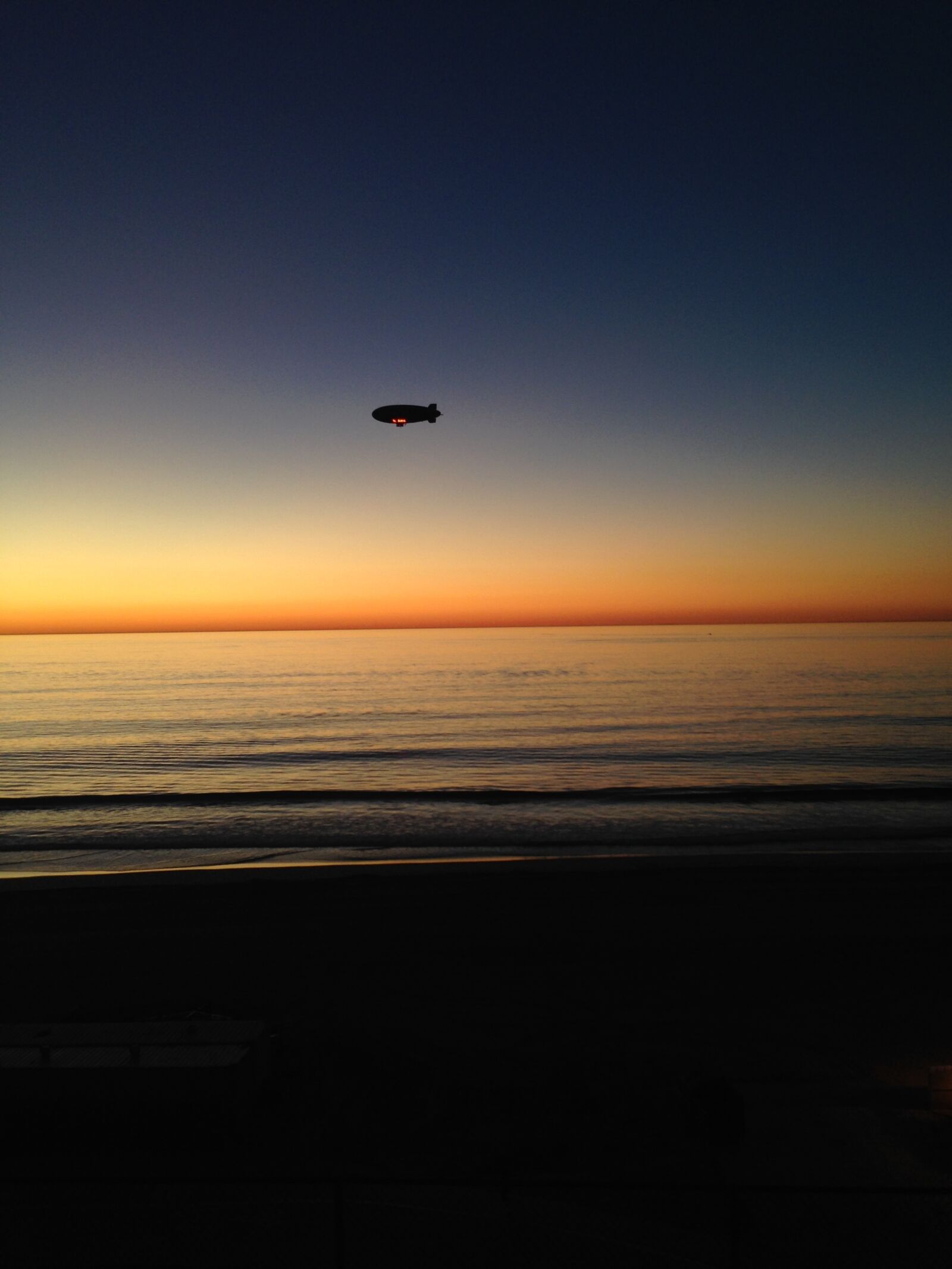 iPhone 5 back camera 4.12mm f/2.4 sample photo. Blimp, beach, sunset photography