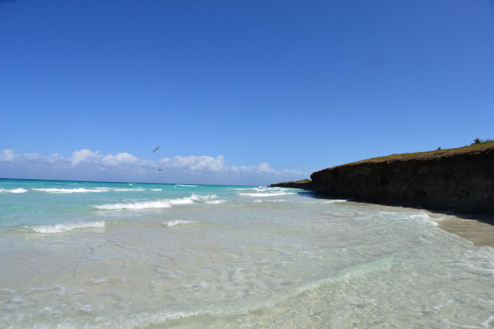 Nikon D3100 sample photo. Beach, clouds, ocean, rocks photography