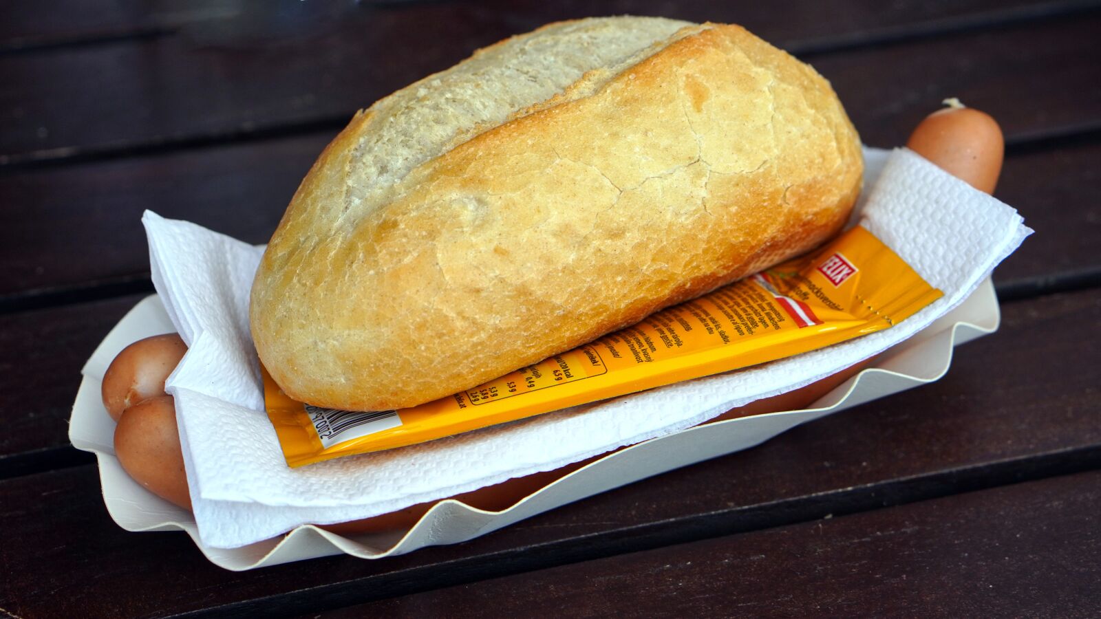 E 50mm F1.8 OSS sample photo. Sausage rolls, mustard, roll photography