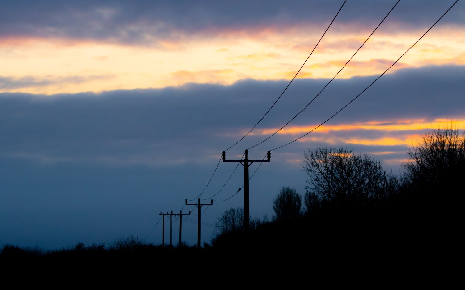 Canon EOS 7D Mark II + Canon EF 100-400mm F4.5-5.6L IS II USM sample photo. Sunrise, silhouette, power lines photography