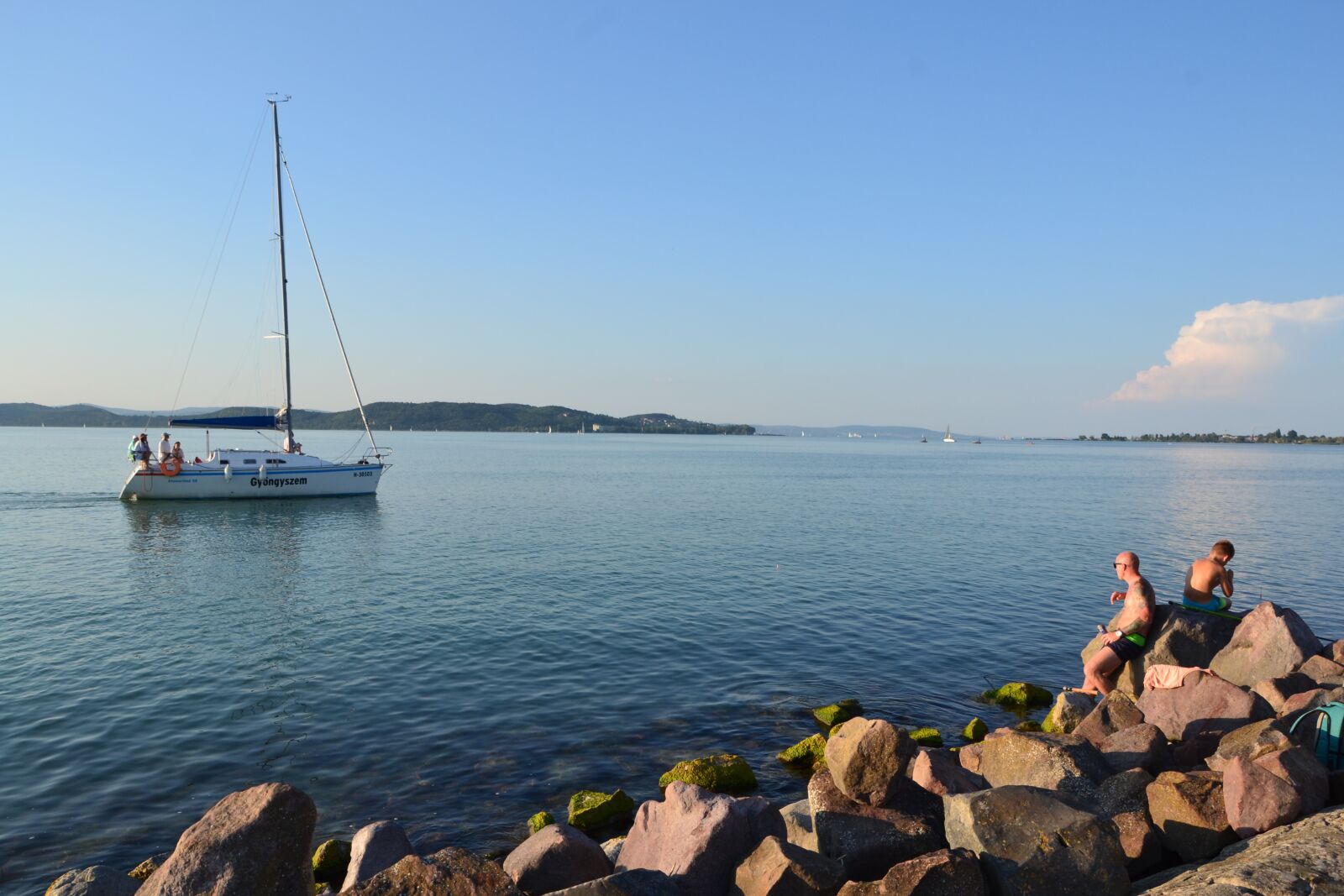 Nikon D3100 sample photo. Lake, boat, rocks photography