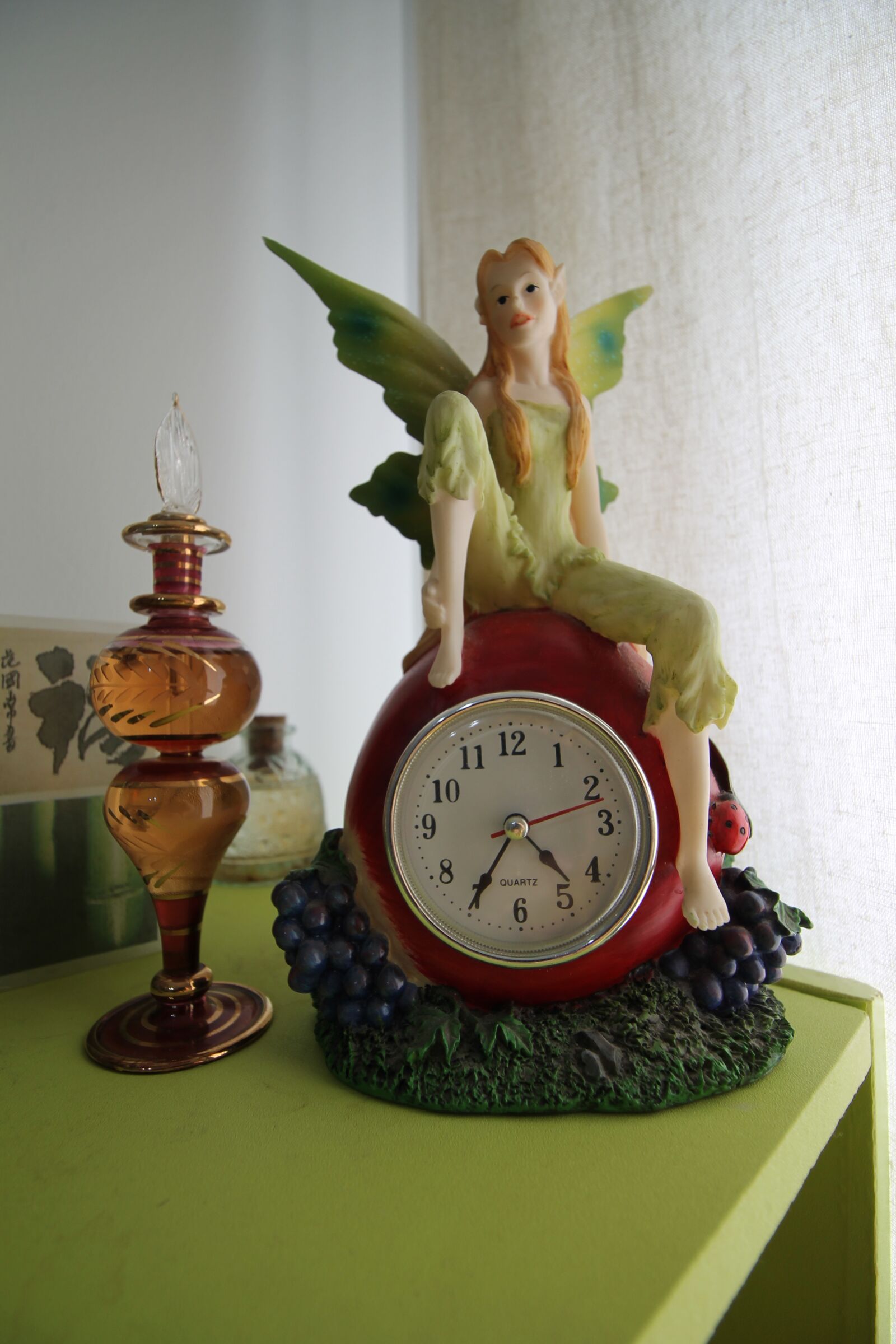 Canon EOS 1100D (EOS Rebel T3 / EOS Kiss X50) + Canon EF-S 10-18mm F4.5–5.6 IS STM sample photo. Fairy, clock, bottle photography