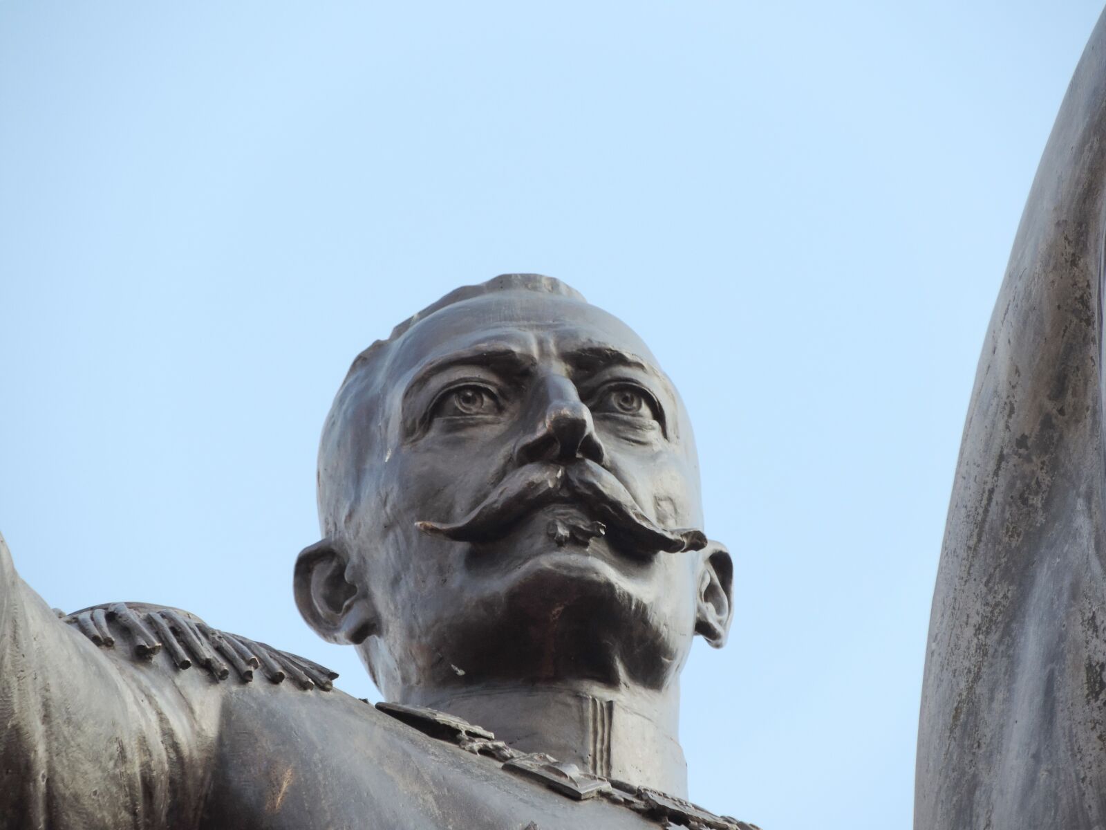 Nikon Coolpix P520 sample photo. Bronze, face, king, mustache photography