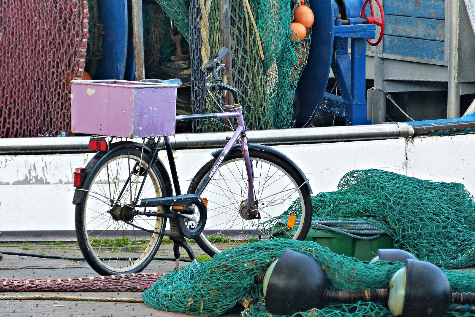 Panasonic Lumix DMC-FZ150 sample photo. Bike, fishing nets, port photography