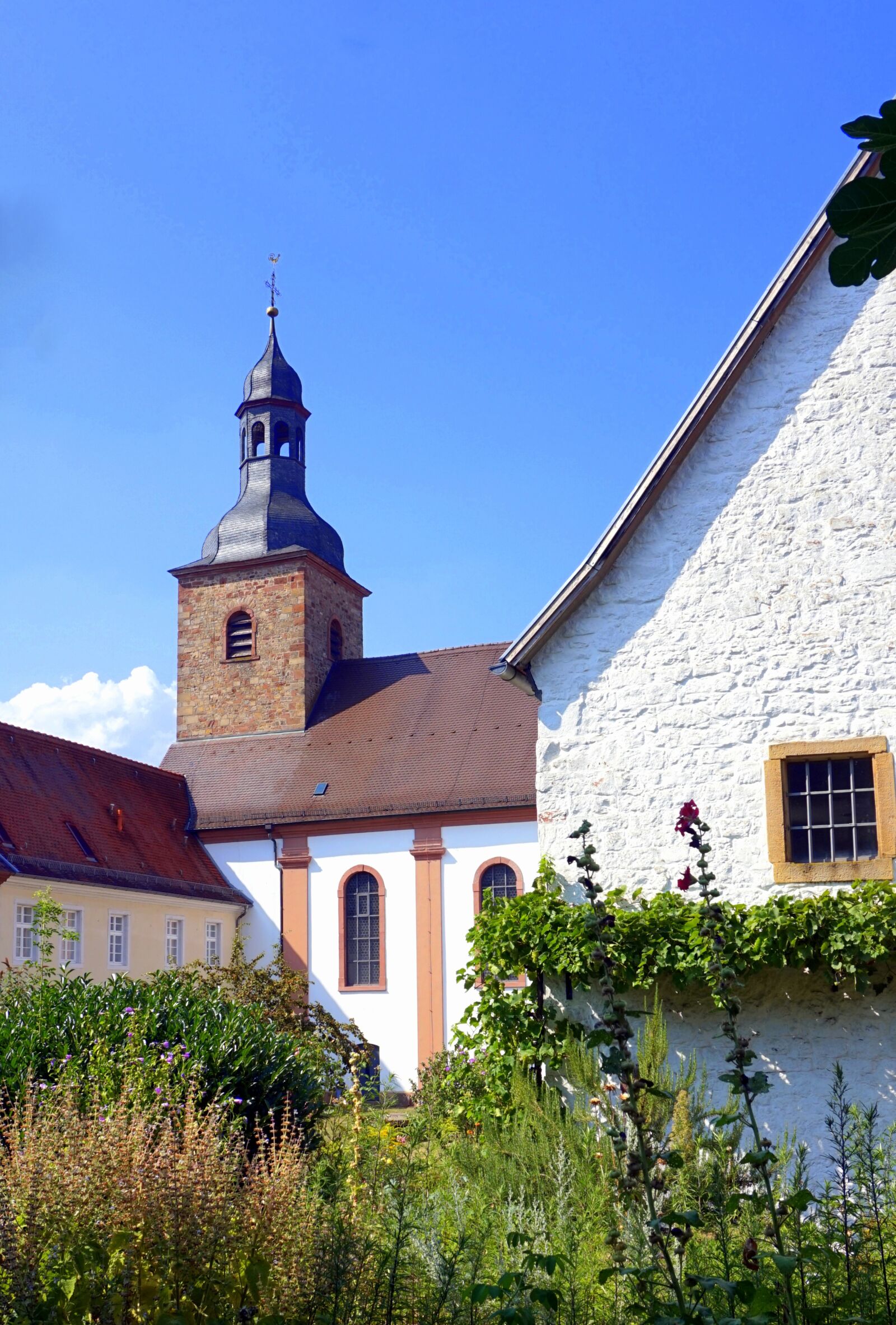 Sony Alpha a5000 (ILCE 5000) sample photo. Village church, garden, steeple photography