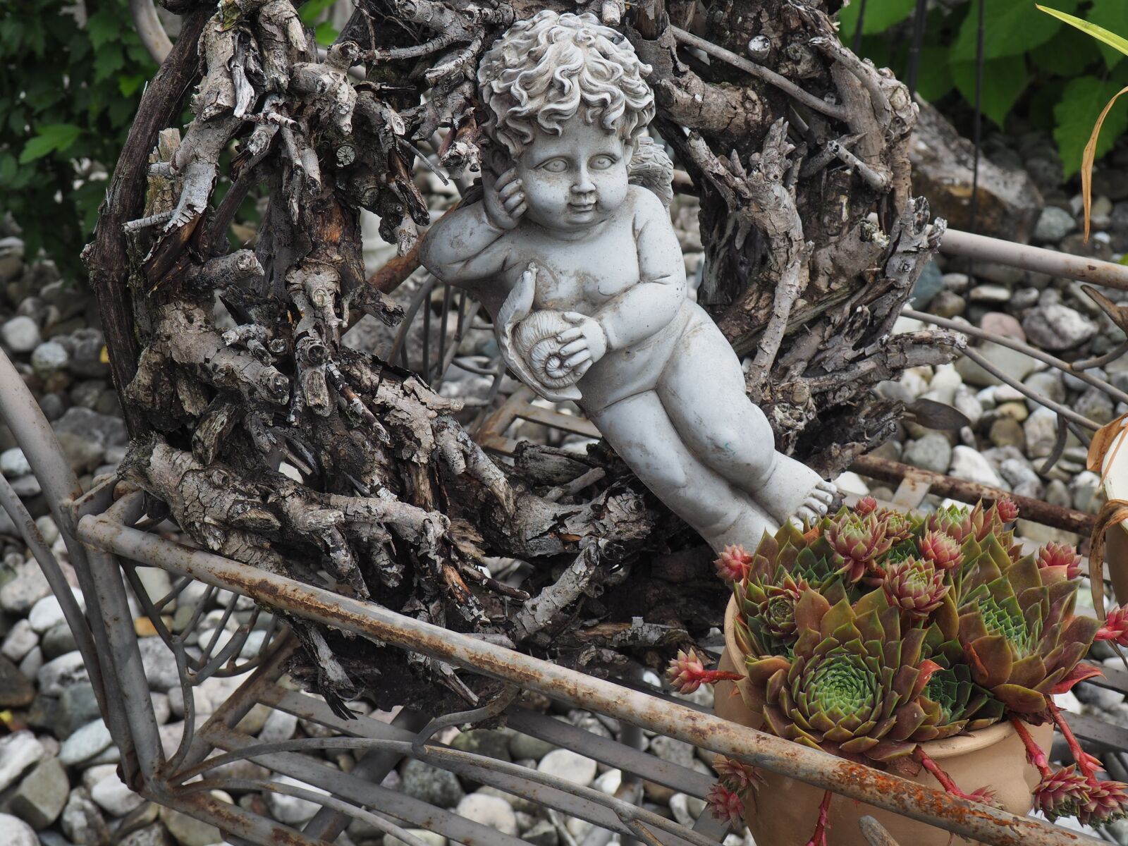 Olympus OM-D E-M10 sample photo. Angel, stone garden, flowers photography