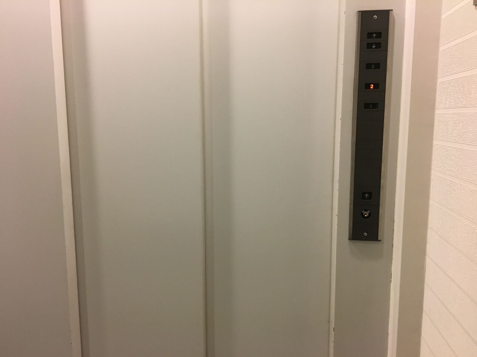 iPhone 6s back camera 4.15mm f/2.2 sample photo. Elevator, door, white photography