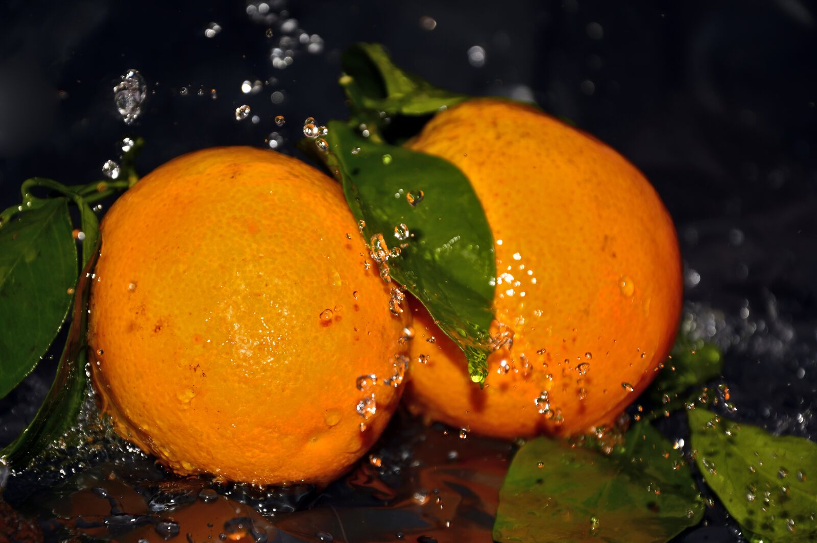 Nikon D3200 sample photo. Oranges, water, spray photography