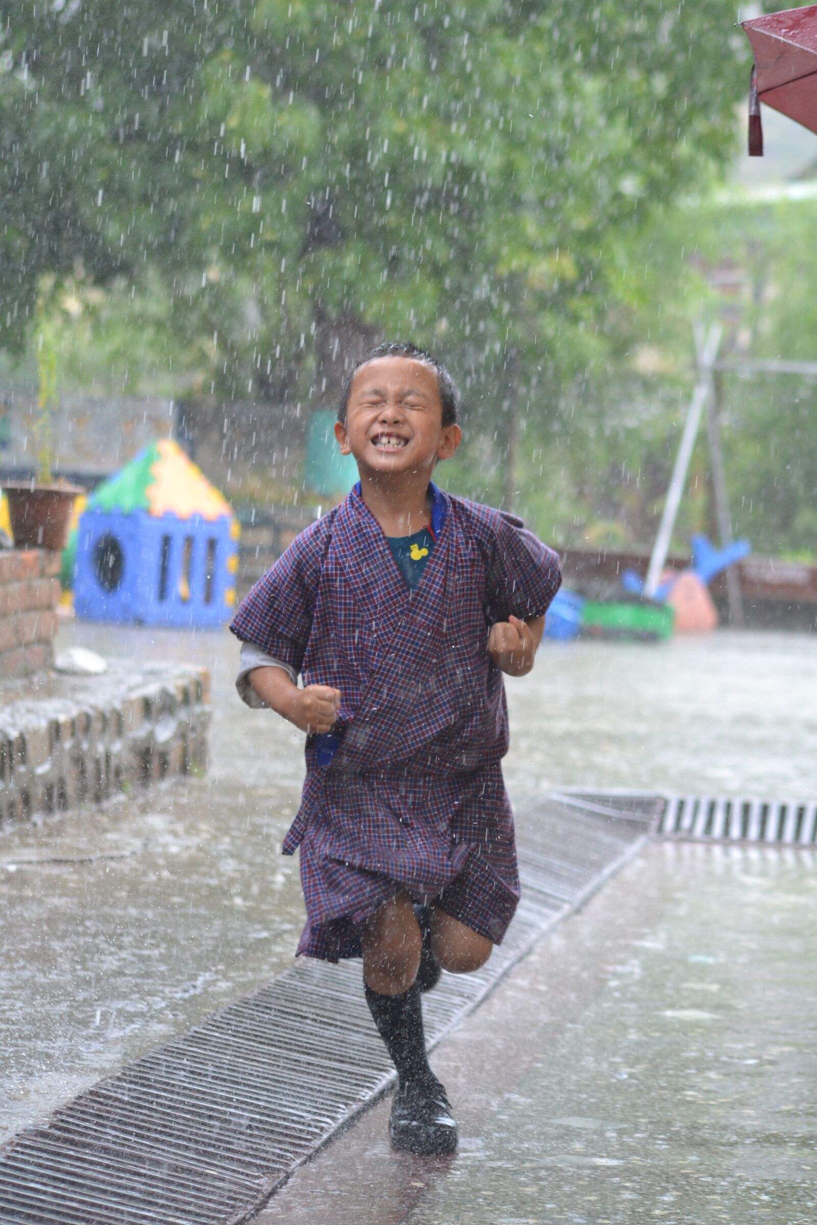 Nikon D3100 sample photo. Boy, running, rain photography