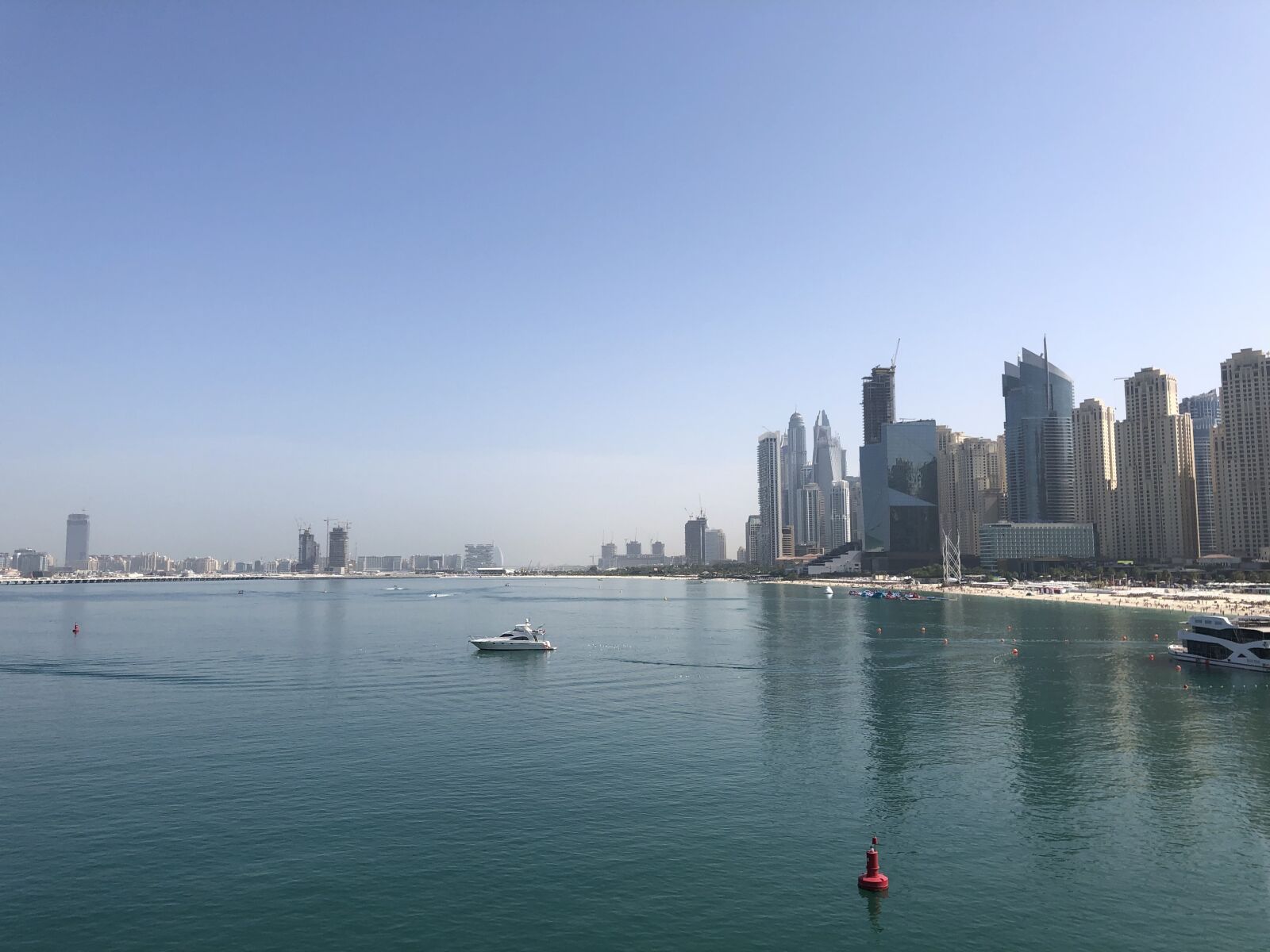 iPhone X back dual camera 4mm f/1.8 sample photo. Dubai, sea, skyscraper photography