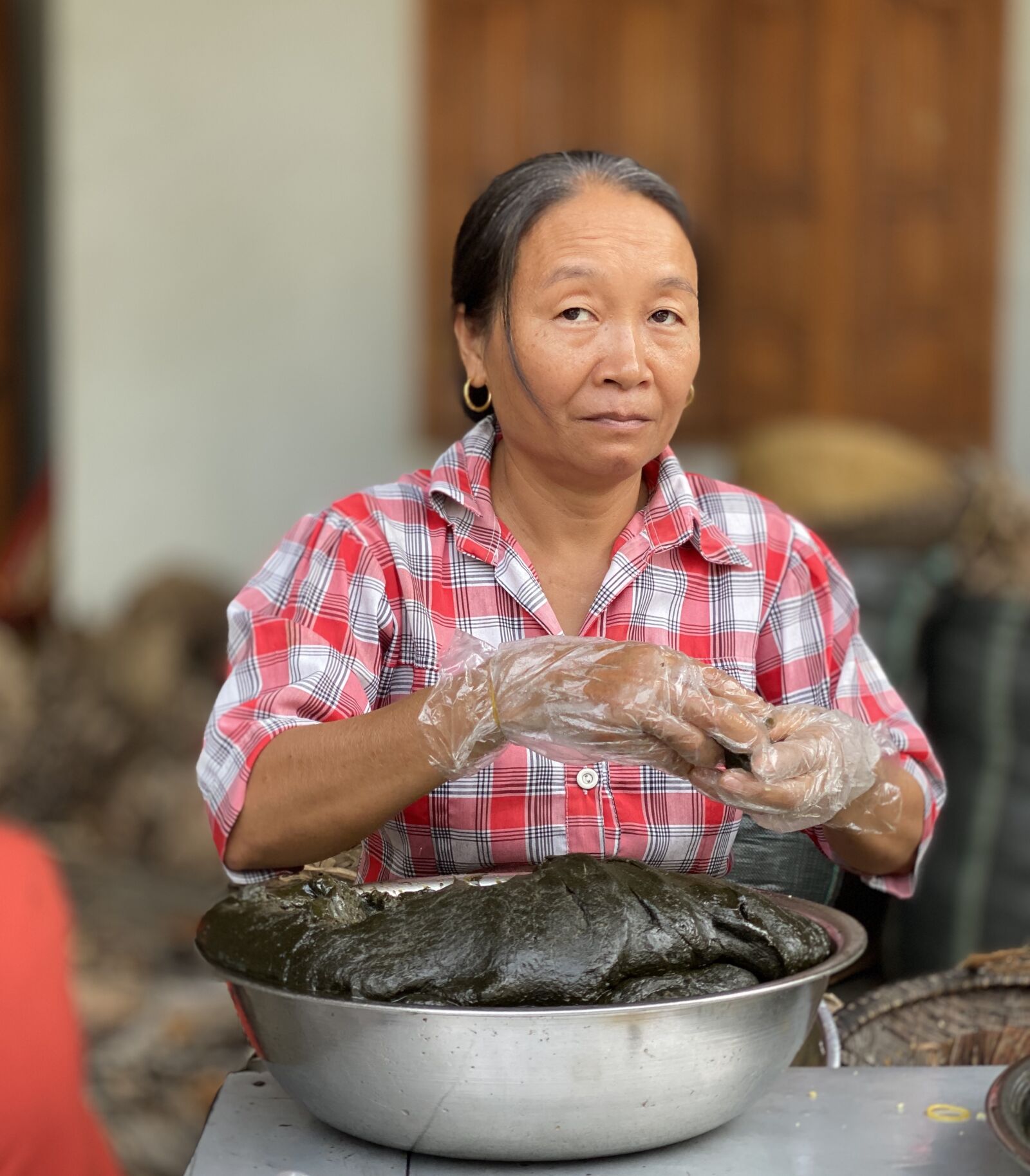 iPhone 11 Pro back dual camera 6mm f/2 sample photo. Woman, vietnam, food preparation photography
