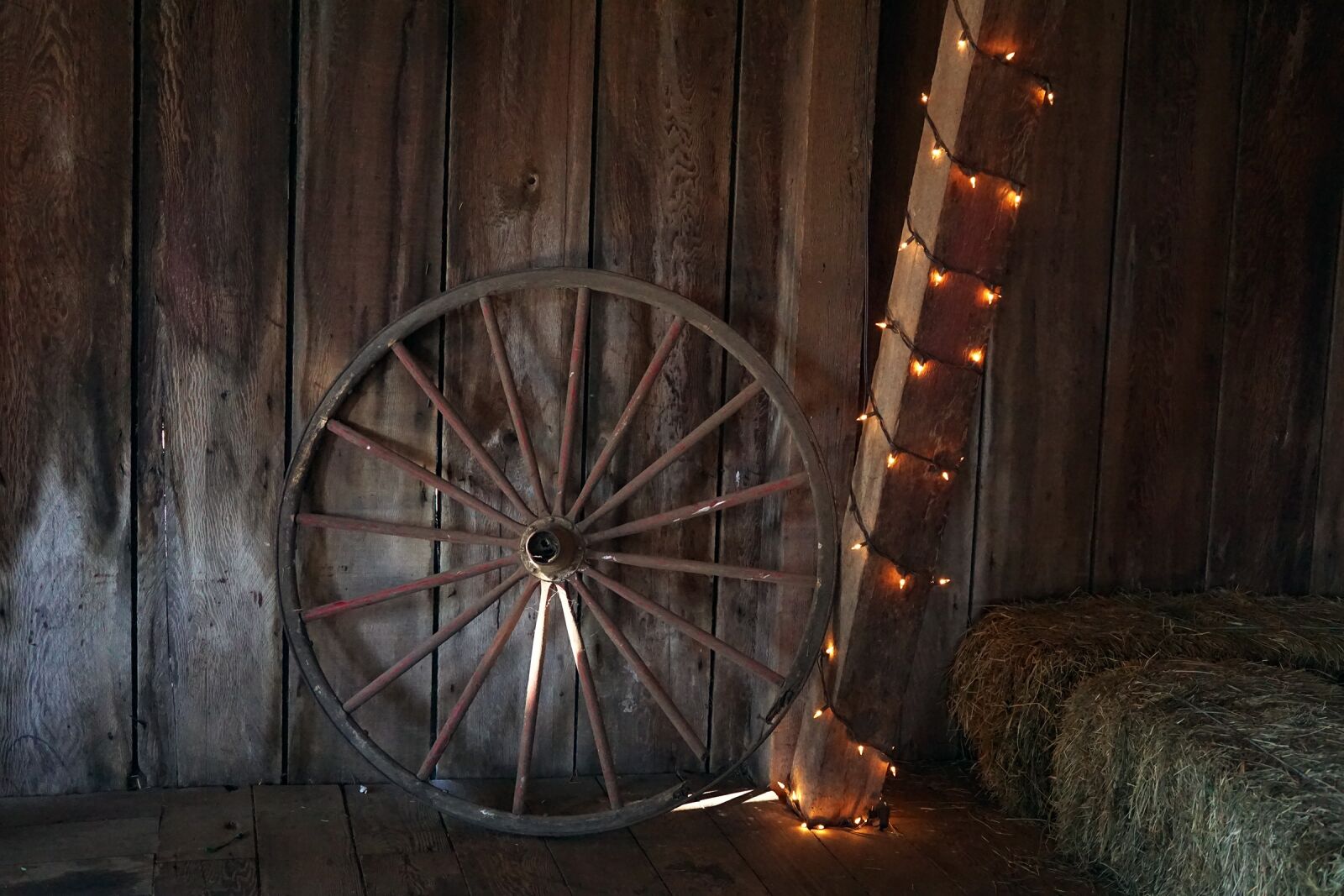 Sony a6000 + Sigma 30mm F2.8 EX DN sample photo. Wagon wheel, barn, hay photography