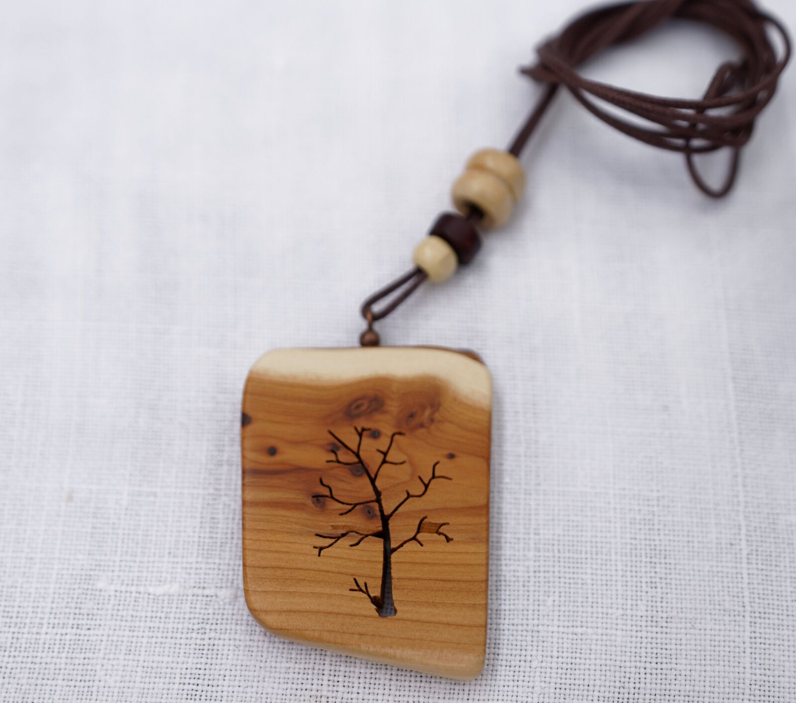 Sony a7R II sample photo. Necklace, tree, wood photography