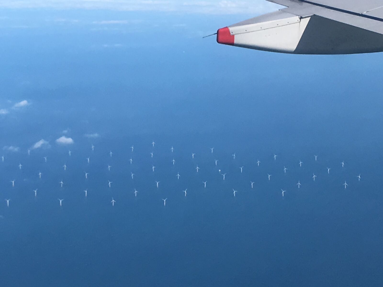 Apple iPhone SE sample photo. Windmills, airplane, north sea photography