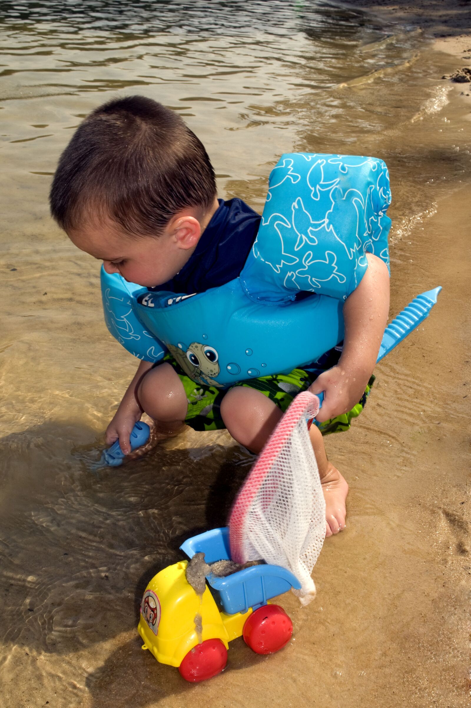 Nikon D300 sample photo. Young boy, kneeling, beach photography